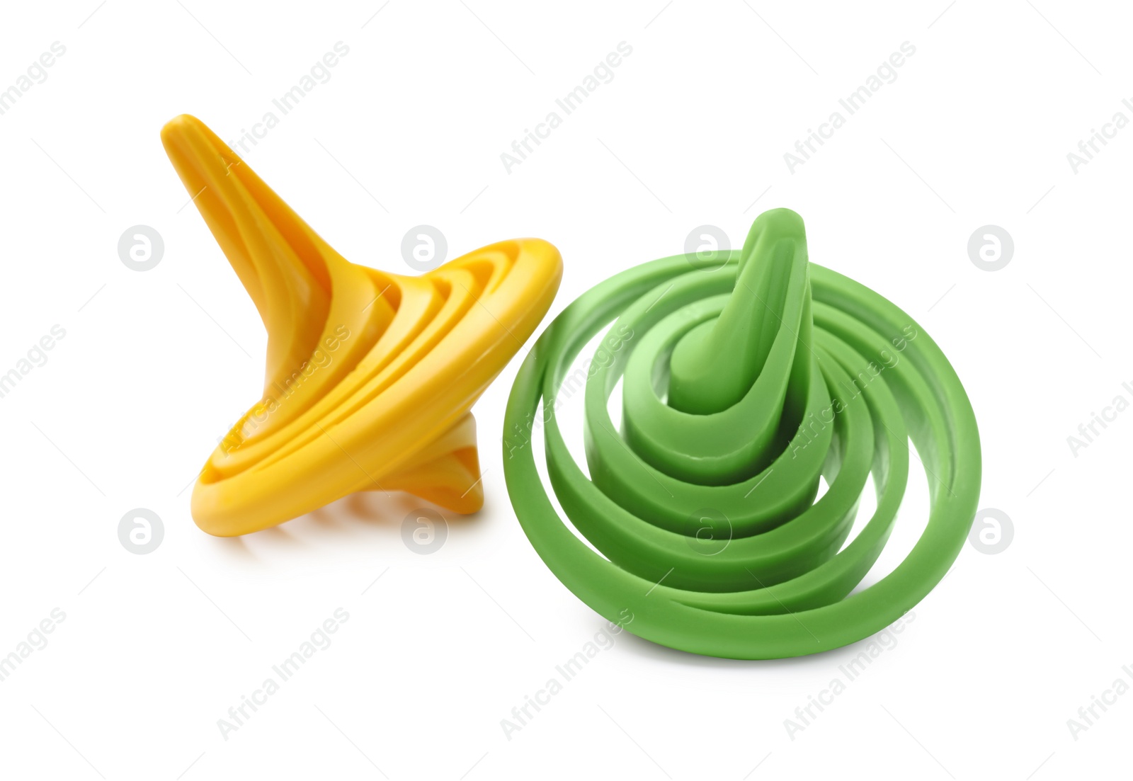 Photo of Two colorful spinning tops on white background