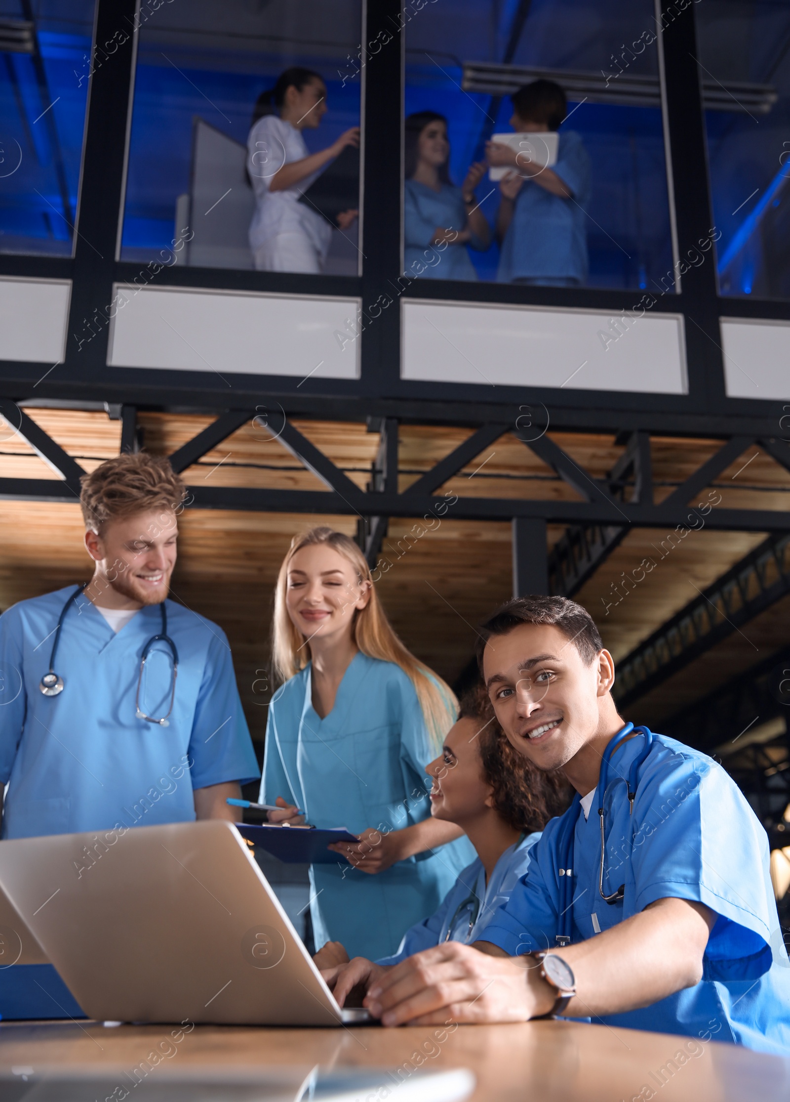 Photo of Group of smart medical students with gadgets in college