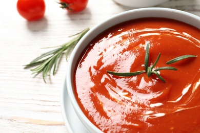 Photo of Bowl with fresh homemade tomato soup on table, closeup. Space for text