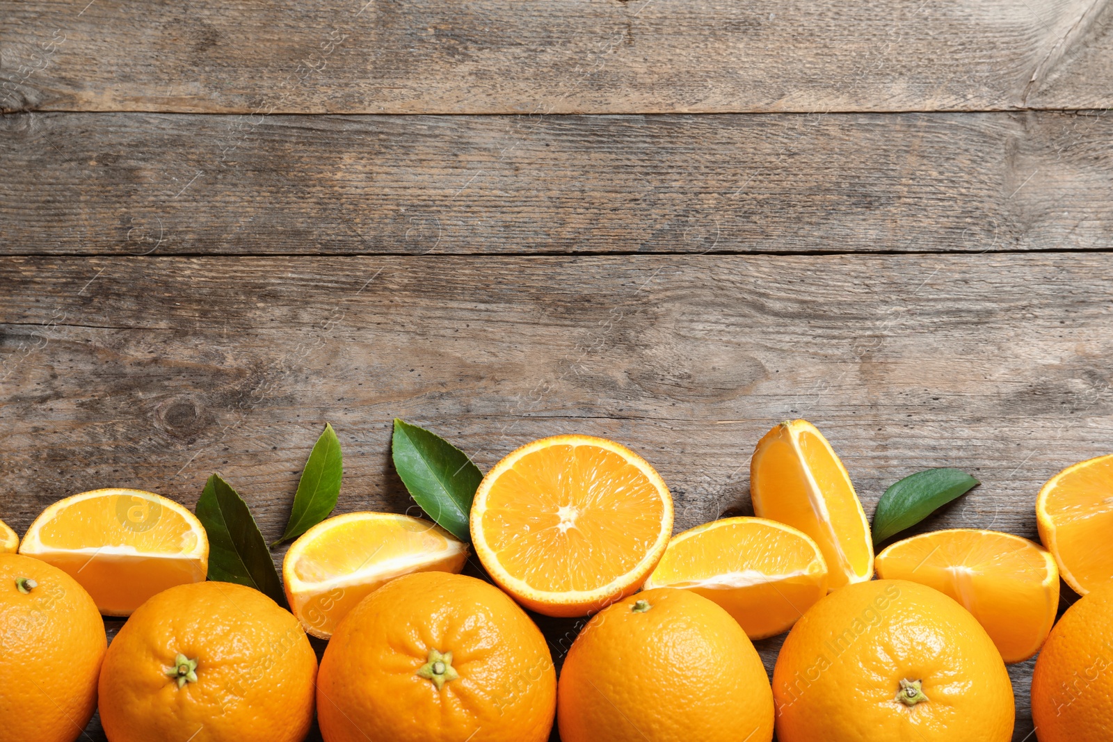 Photo of Flat lay composition with ripe oranges and space for text on wooden background