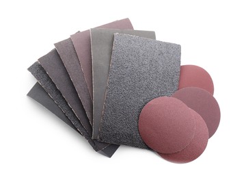 Photo of Many sheets of sandpaper isolated on white, top view