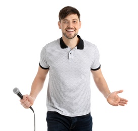 Handsome man in casual clothes posing with microphone on white background