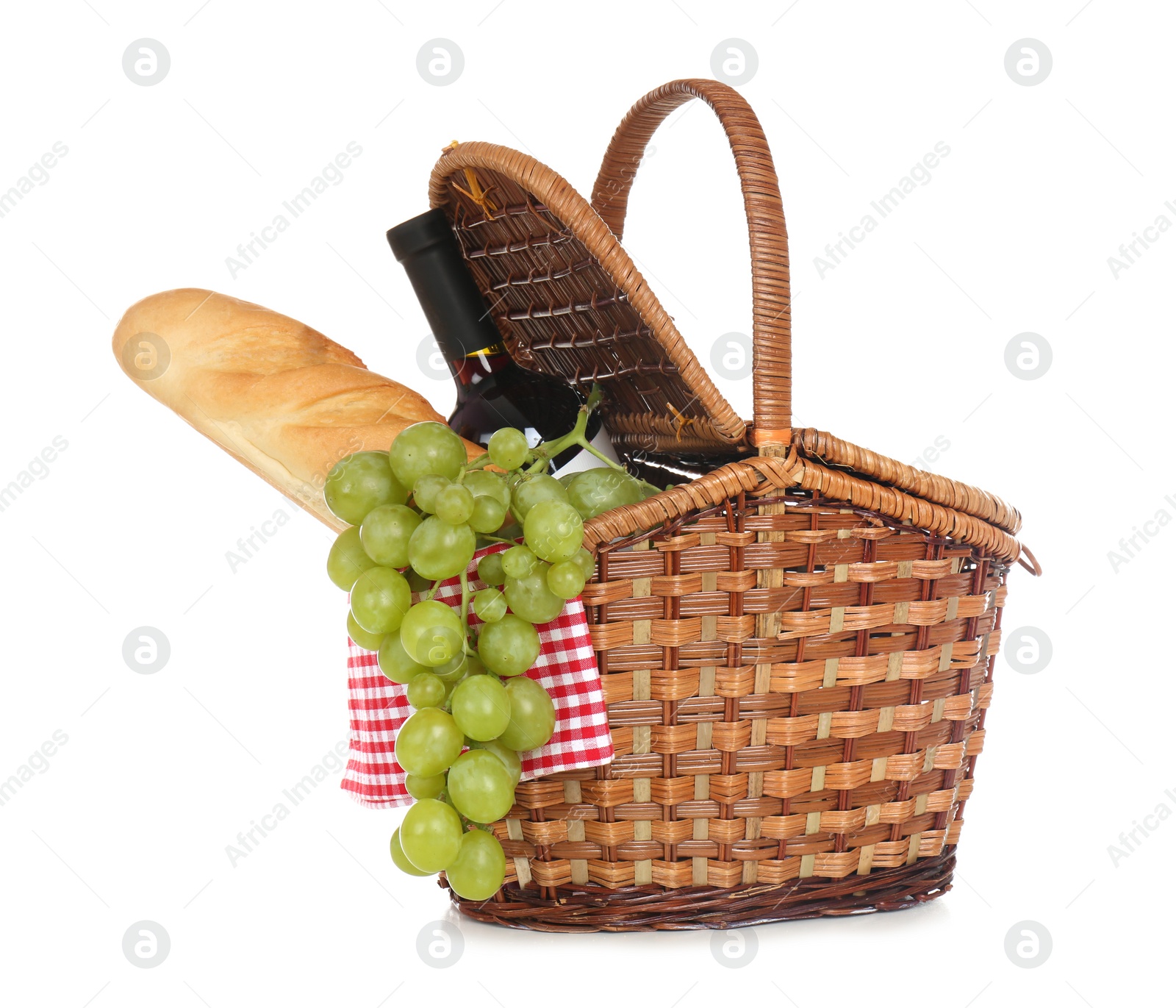 Photo of Wicker basket for picnic filled with food on white background