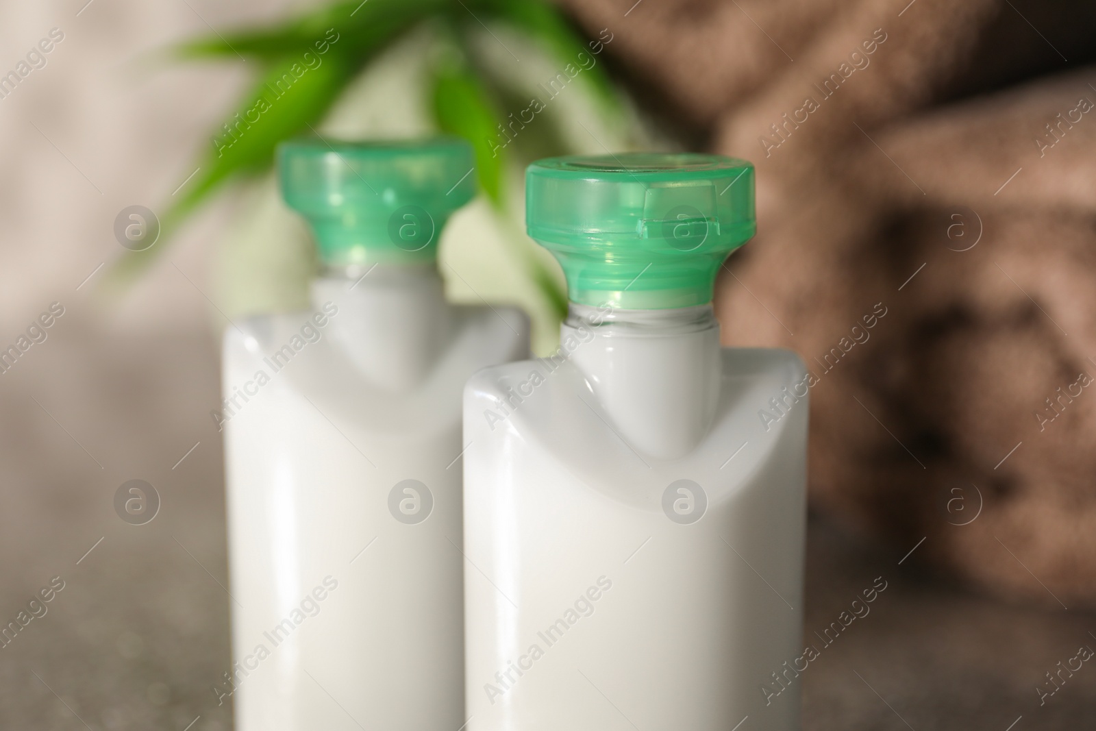 Photo of Mini bottles of cosmetic products on table, closeup