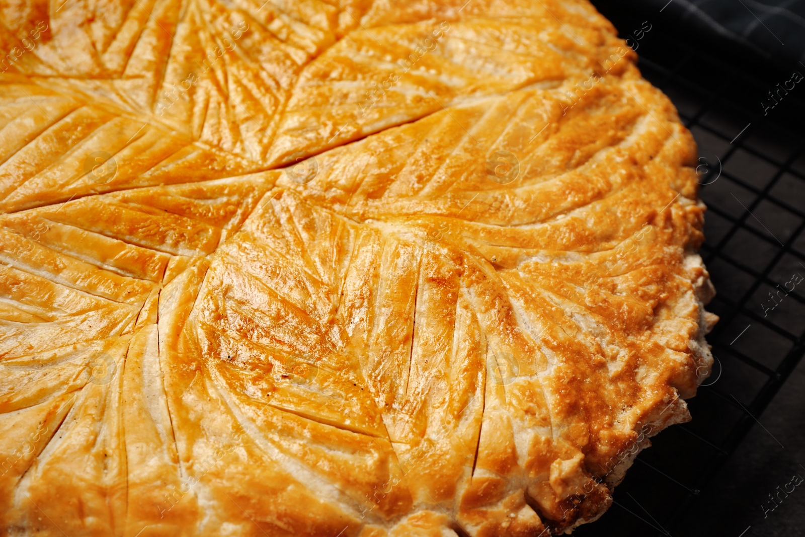 Photo of Traditional galette des rois on cooling rack, closeup