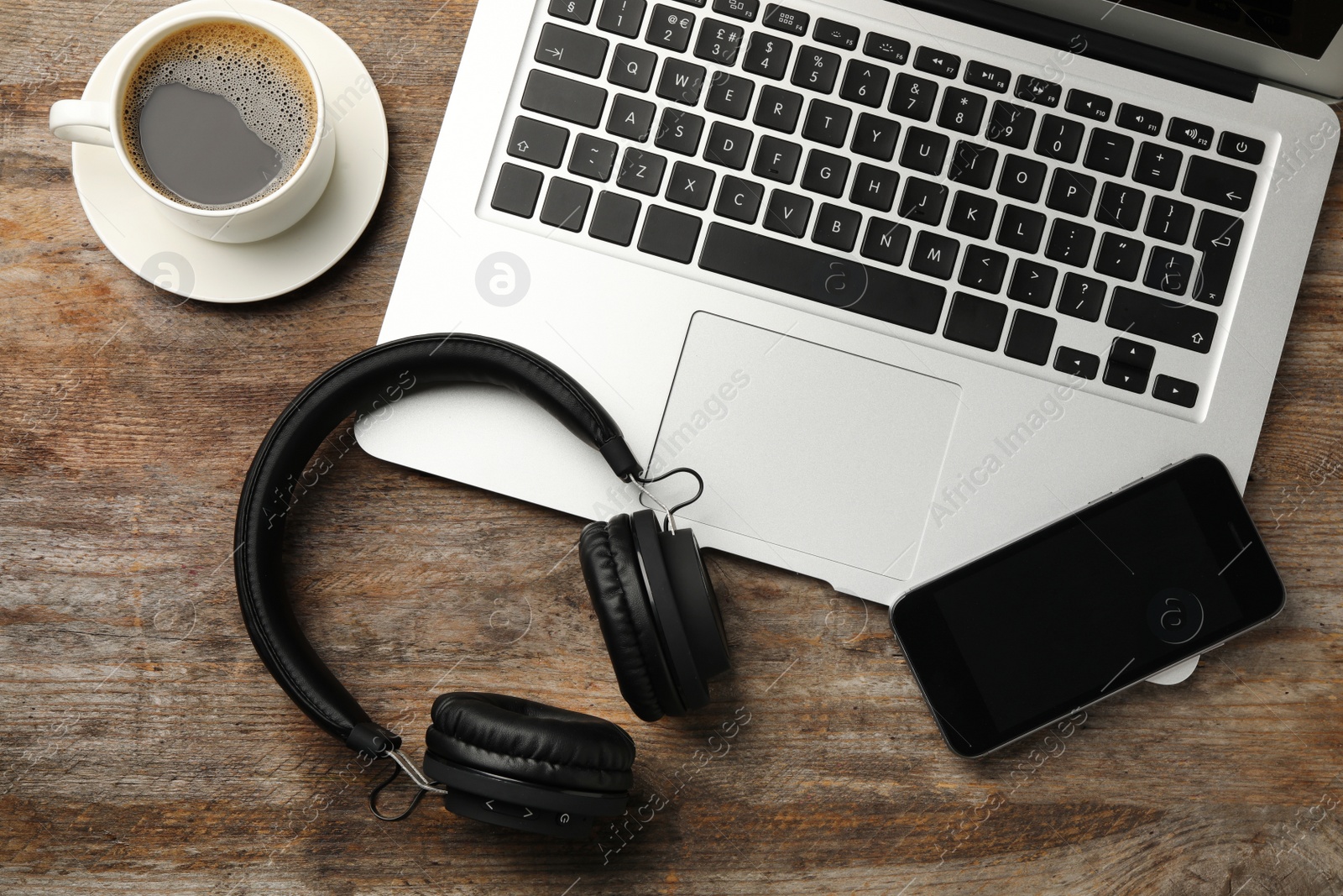 Photo of Flat lay composition with headphones, laptop and smartphone on table