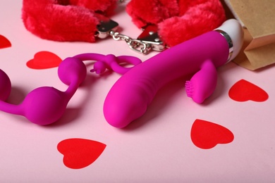 Photo of Set of different sex toys on pink background
