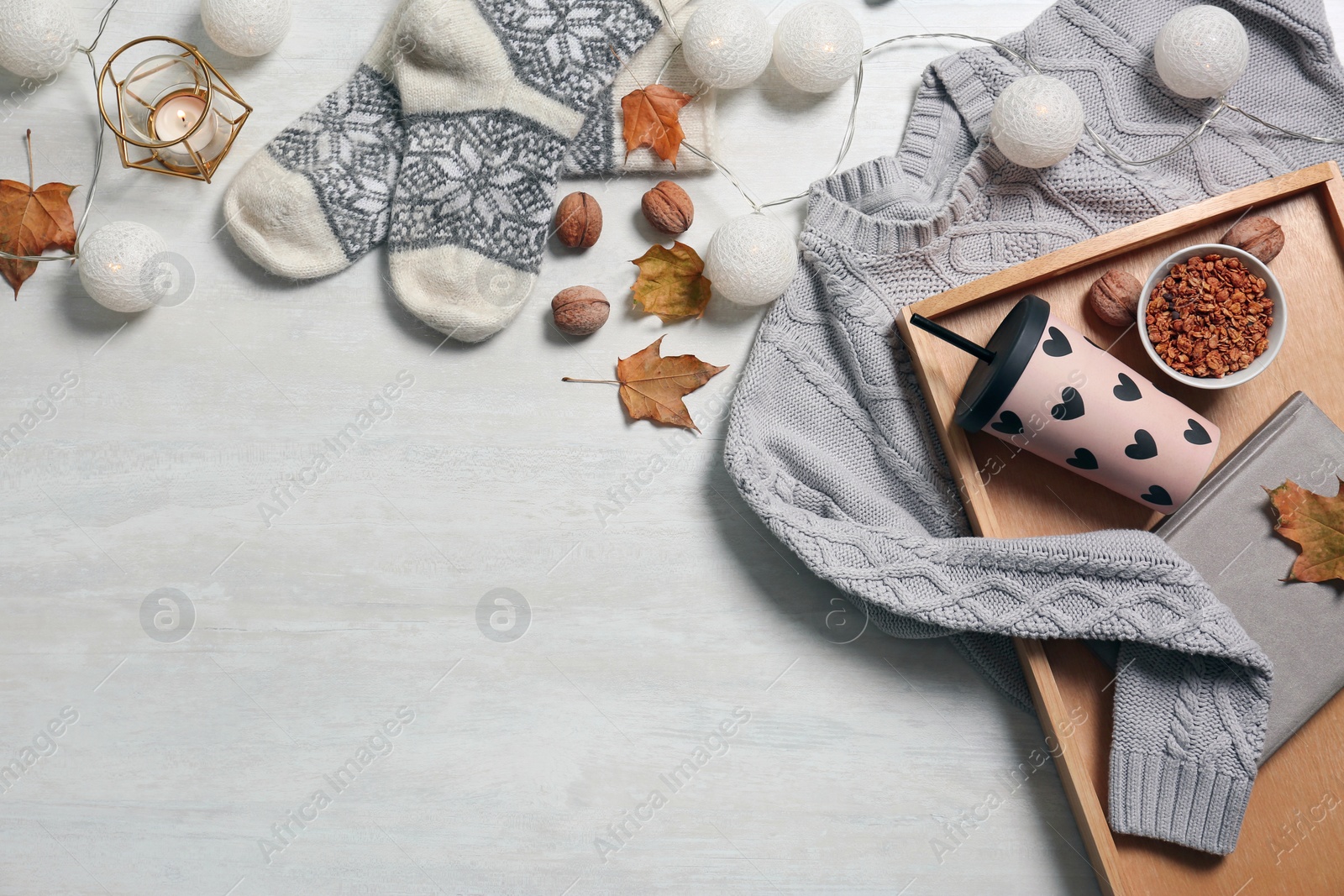 Photo of Flat lay composition with warm sweater and space for text on light background