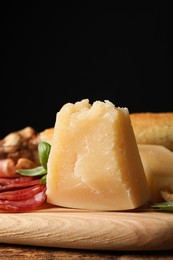 Photo of Snack platter with parmesan cheese served on wooden table, closeup