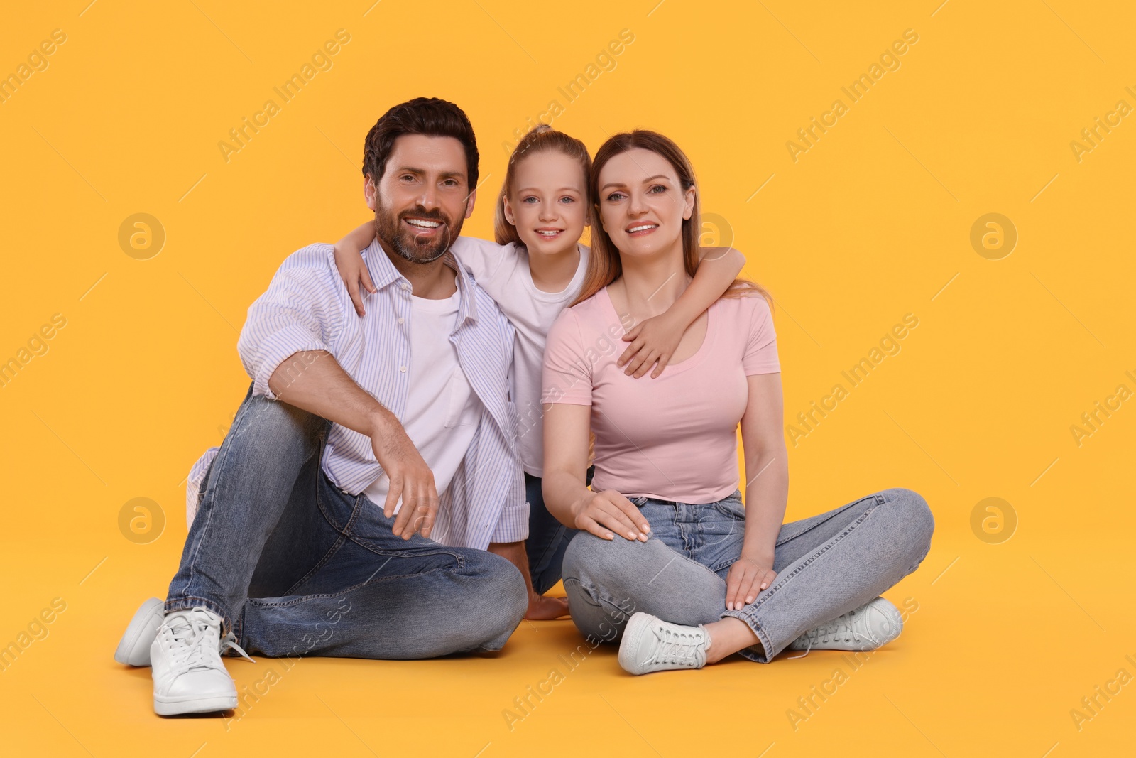 Photo of Portrait of happy family on orange background