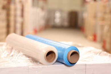 Photo of Rolls of different stretch wraps on boxes in warehouse