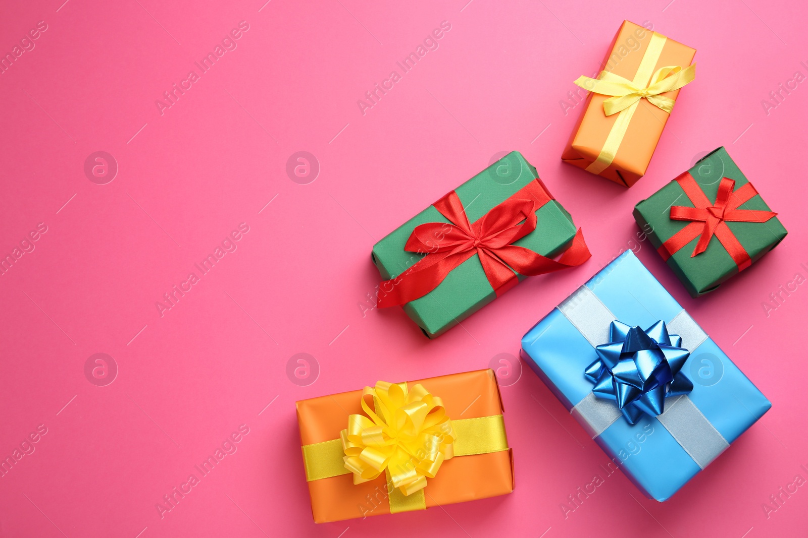 Photo of Many colorful gift boxes on pink background, flat lay. Space for text
