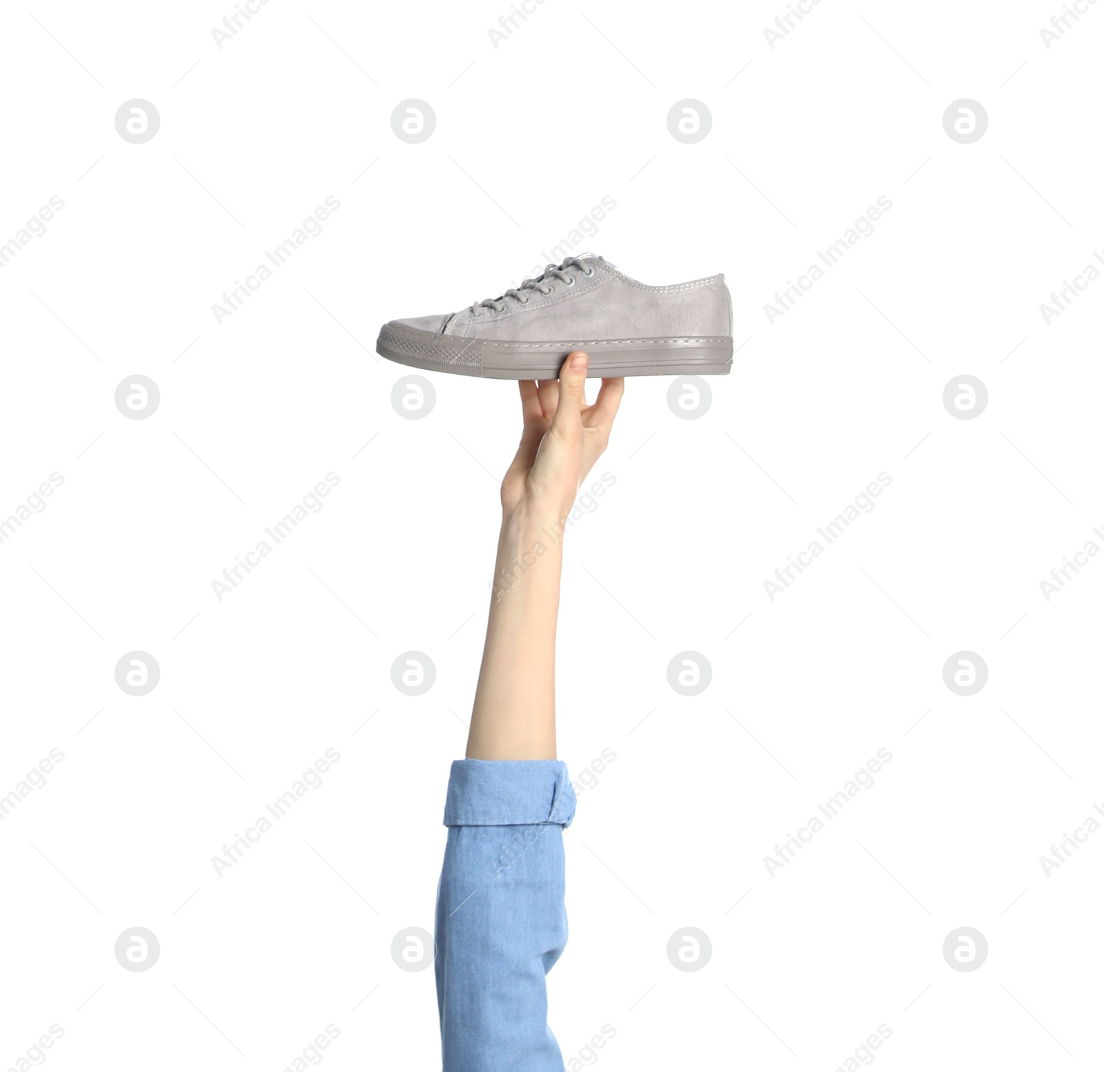 Photo of Woman holding sportive shoe on white background, closeup