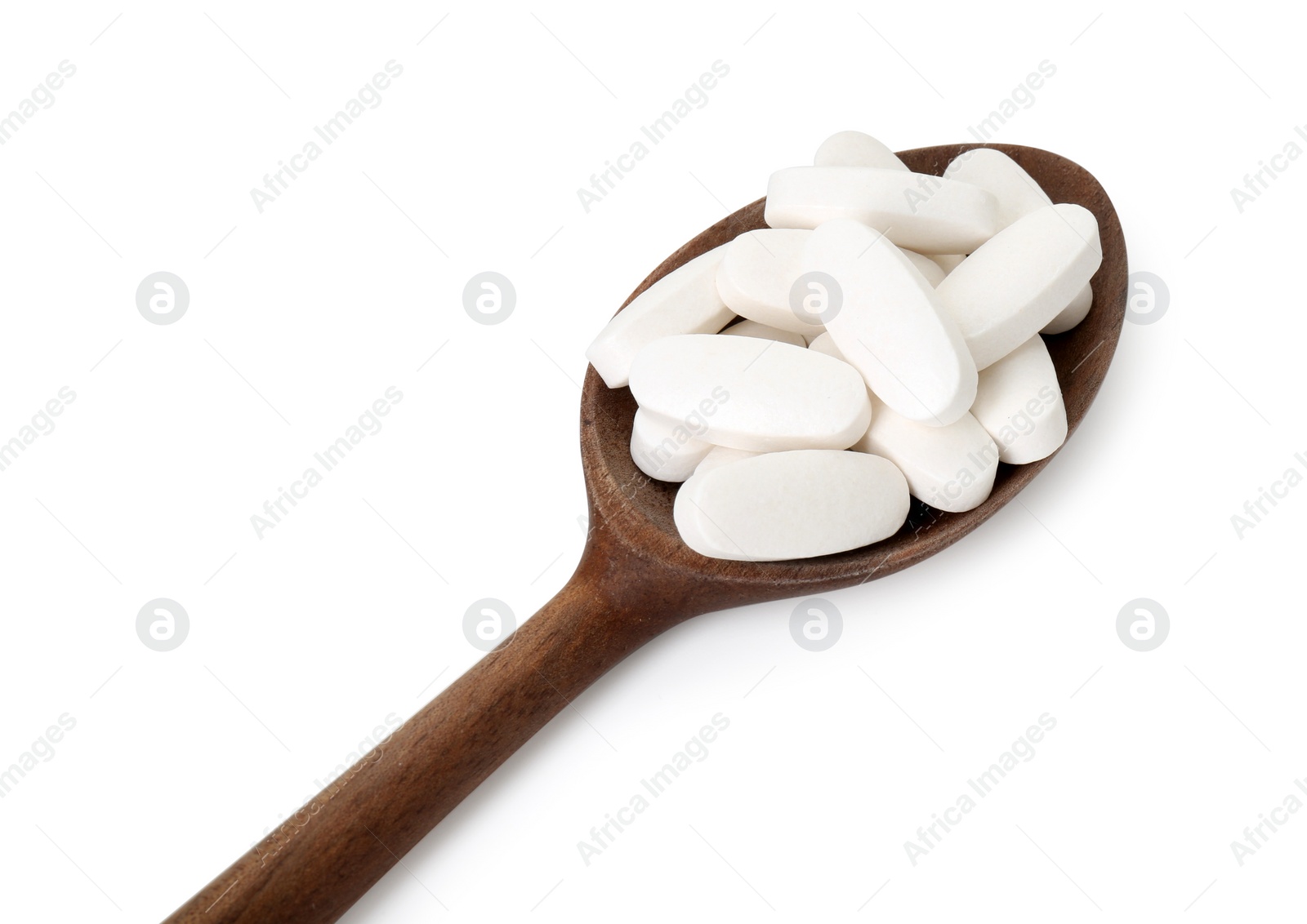 Photo of Vitamin pills in wooden spoon isolated on white. Health supplement