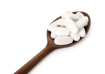 Photo of Vitamin pills in wooden spoon isolated on white. Health supplement