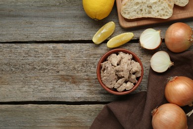 Photo of Flat lay composition with tasty cod liver and different products on wooden table. Space for text