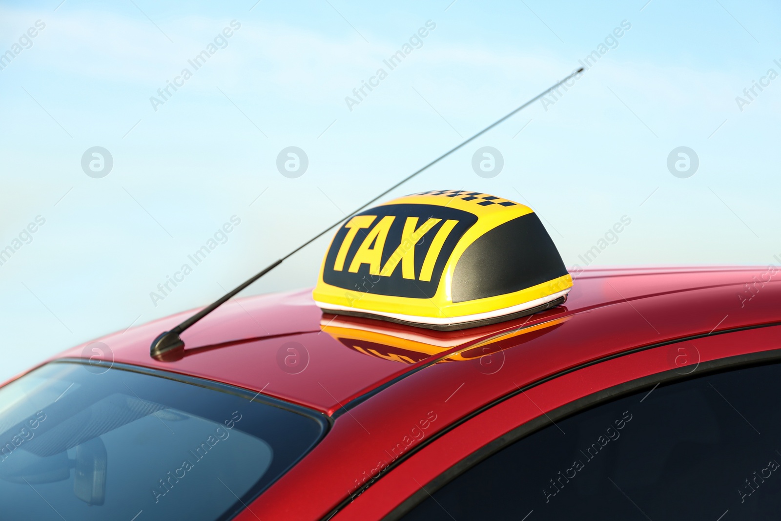 Photo of Roof light with word TAXI on car outdoors