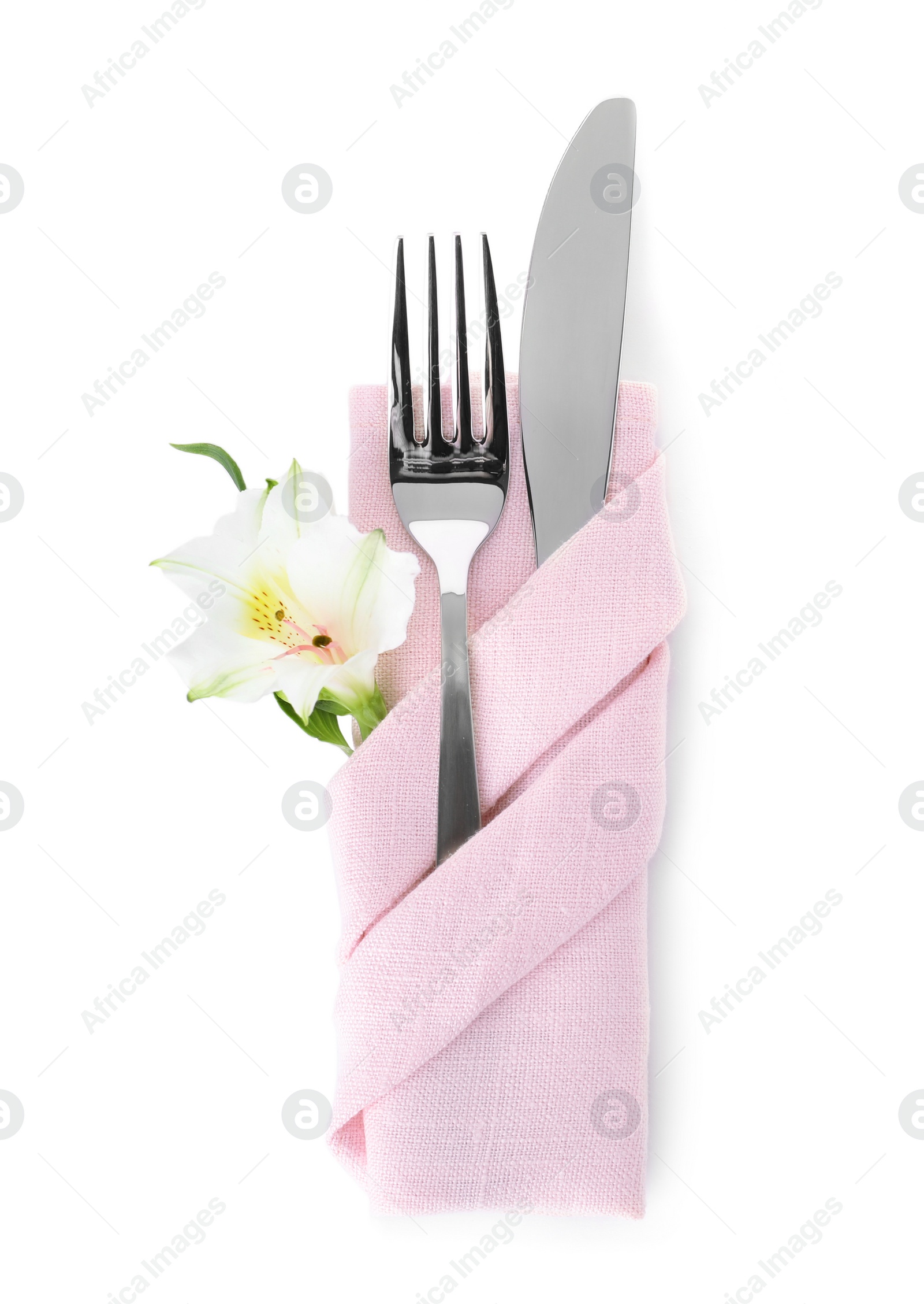 Photo of Folded napkin with fork, knife and flower on white background, top view