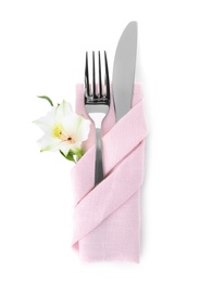 Photo of Folded napkin with fork, knife and flower on white background, top view