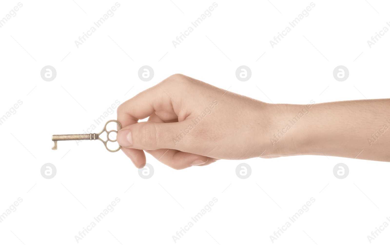 Photo of Woman holding bronze vintage ornate key on white background, closeup