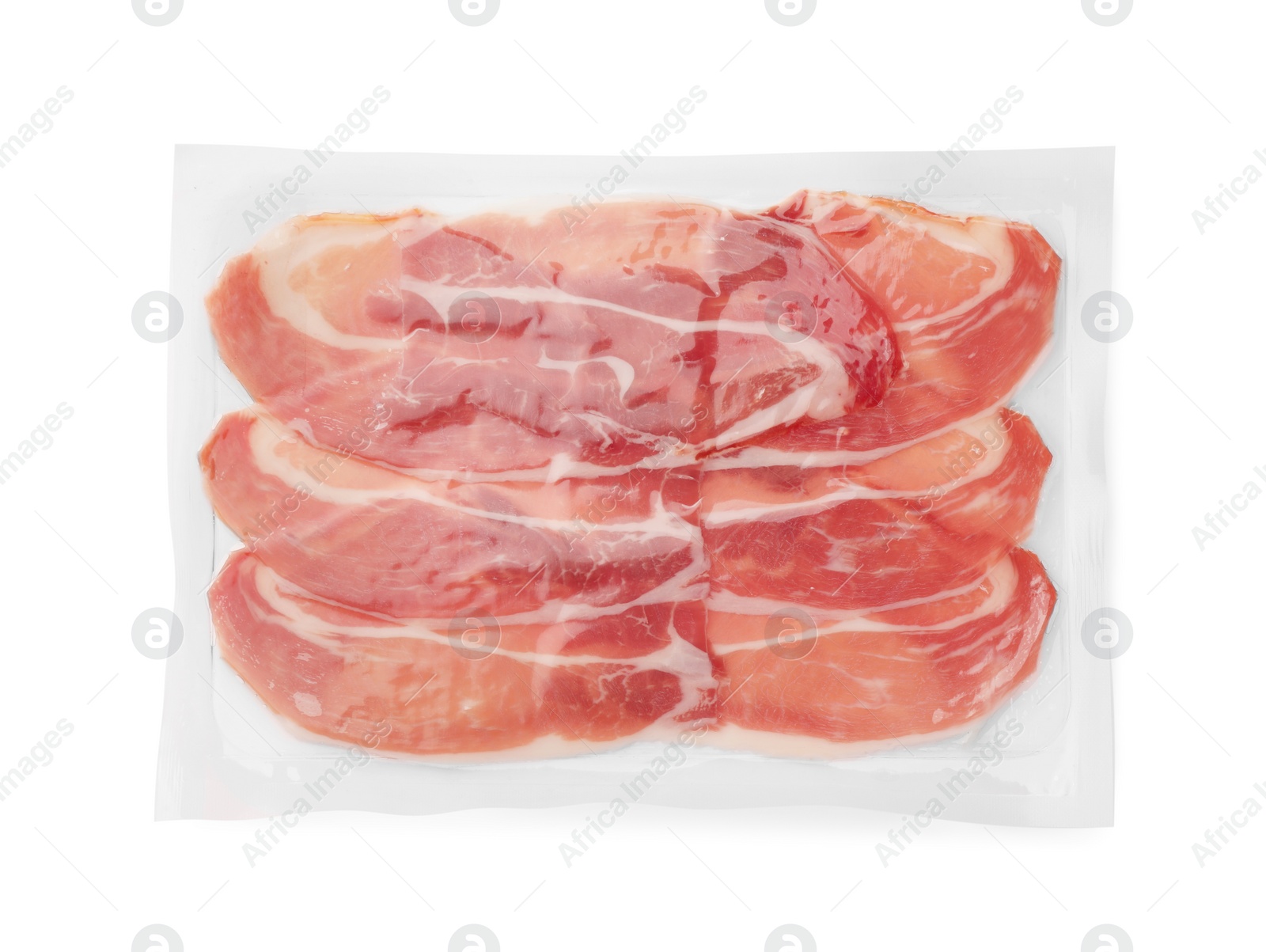 Photo of Pack of delicious sliced jamon isolated on white, top view