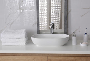 Modern mirror and vessel sink in stylish bathroom