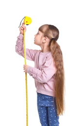 Photo of Little girl measuring her height on white background