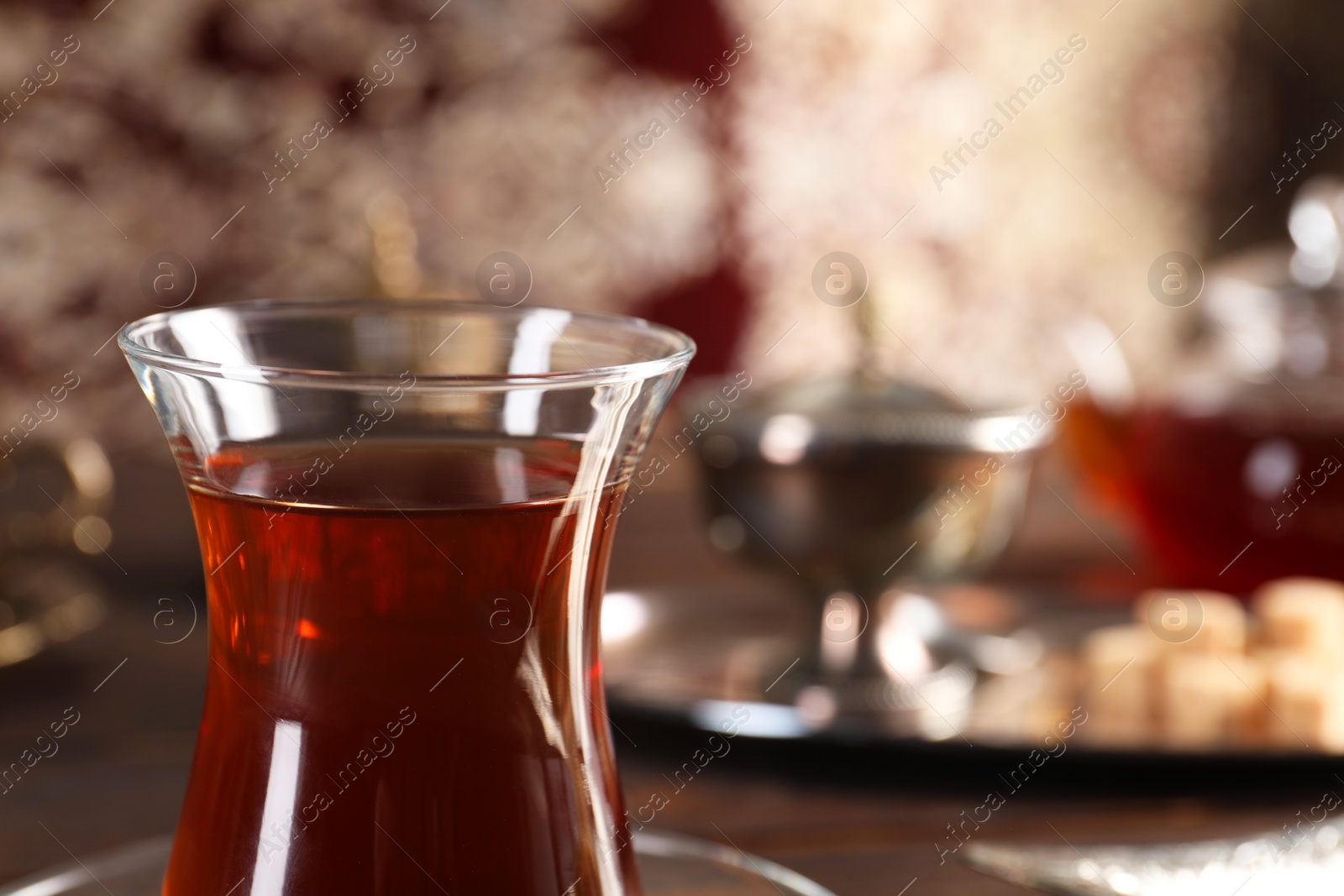 Photo of Traditional Turkish tea in glass on table, closeup. Space for text