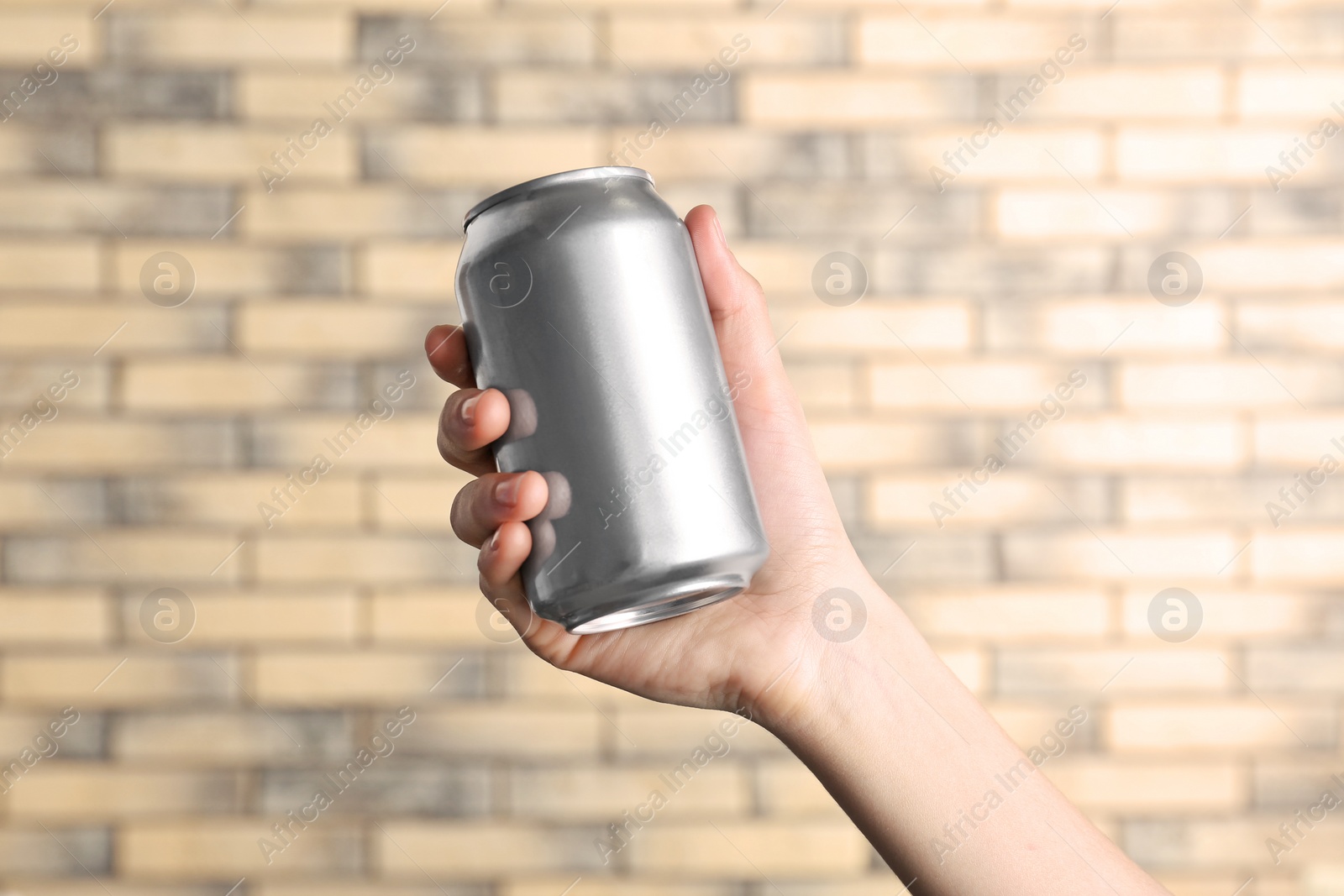 Photo of Woman holding aluminum can on blurred background
