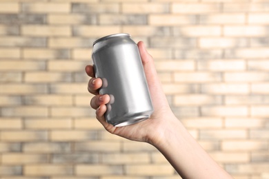 Photo of Woman holding aluminum can on blurred background