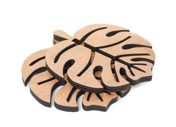 Photo of Leaf shaped wooden cup coasters on white background