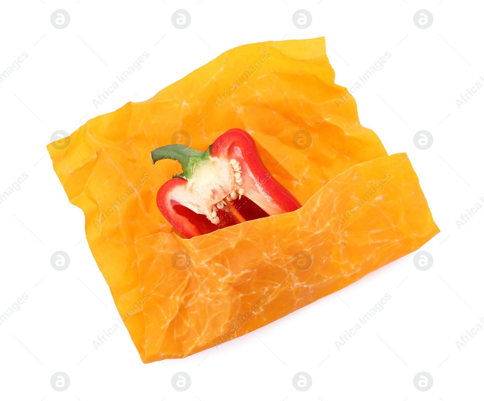 Photo of Bell pepper in beeswax food wrap isolated on white, top view