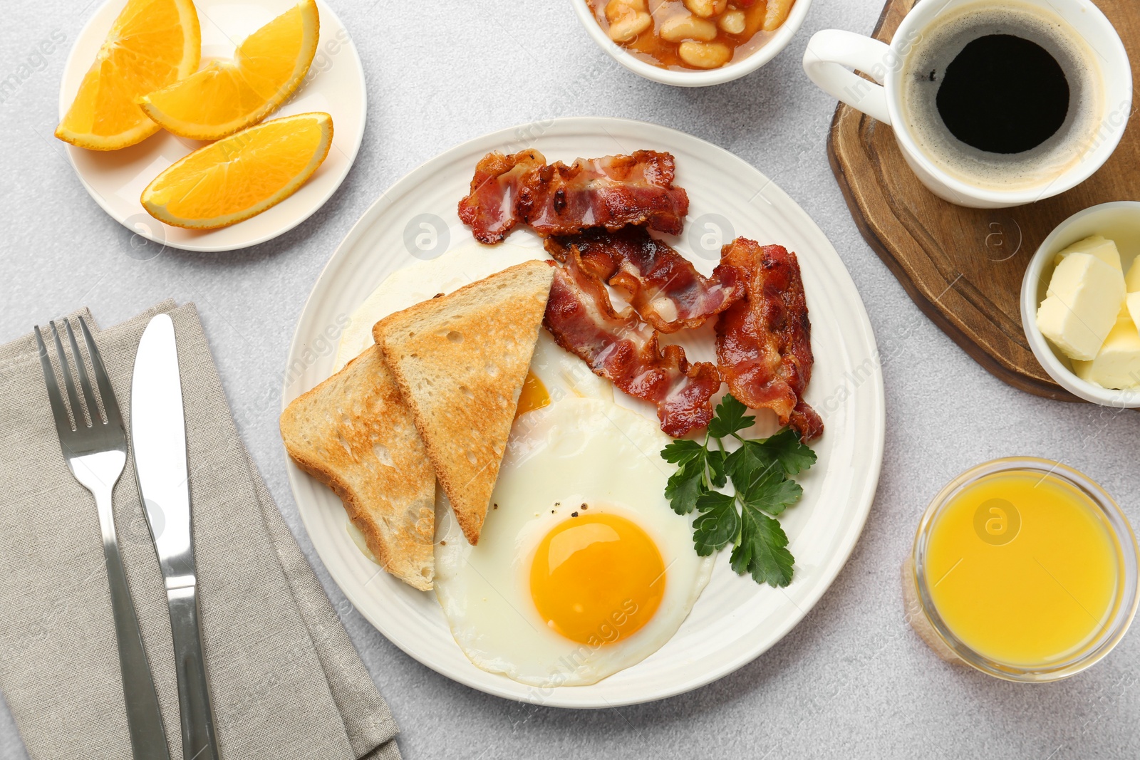 Photo of Delicious breakfast with sunny side up egg served on light table, flat lay
