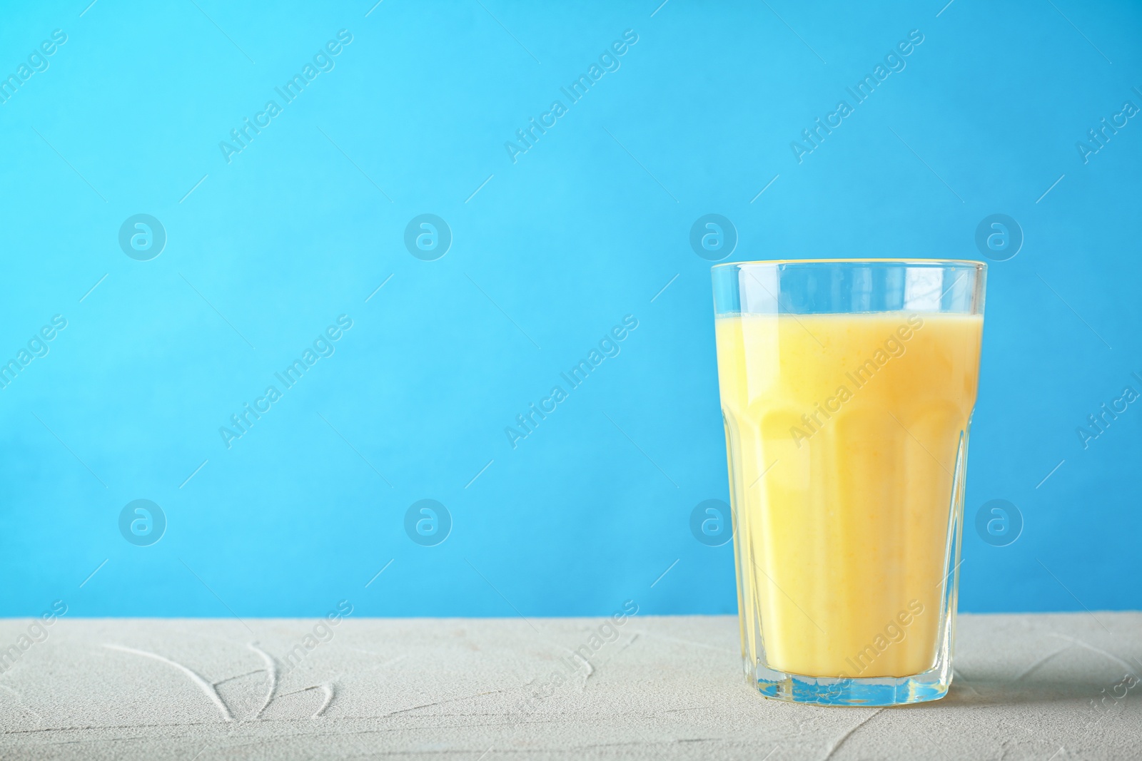 Photo of Glass with delicious detox smoothie on table