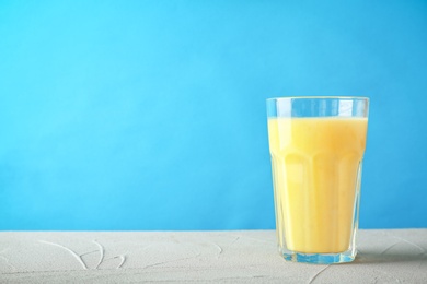 Glass with delicious detox smoothie on table