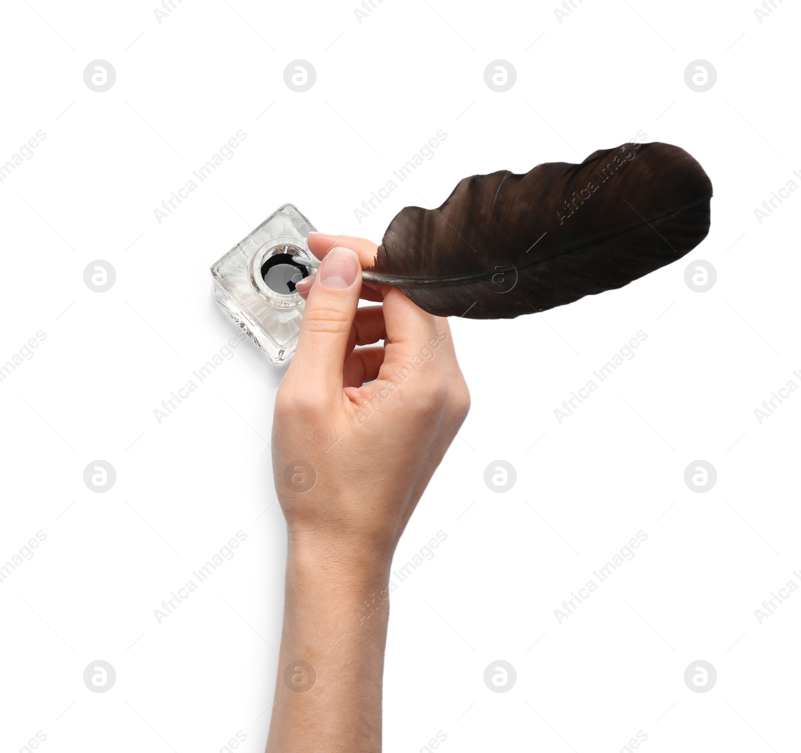 Photo of Woman dipping feather pen into inkwell on white background, top view