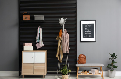 Hallway interior with stylish furniture, clothes and accessories