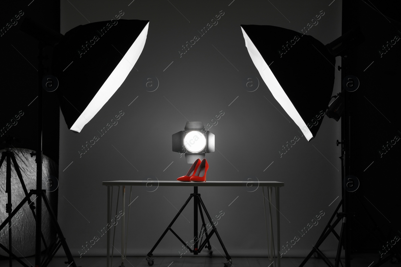 Photo of Professional photography equipment prepared for shooting stylish shoes in studio