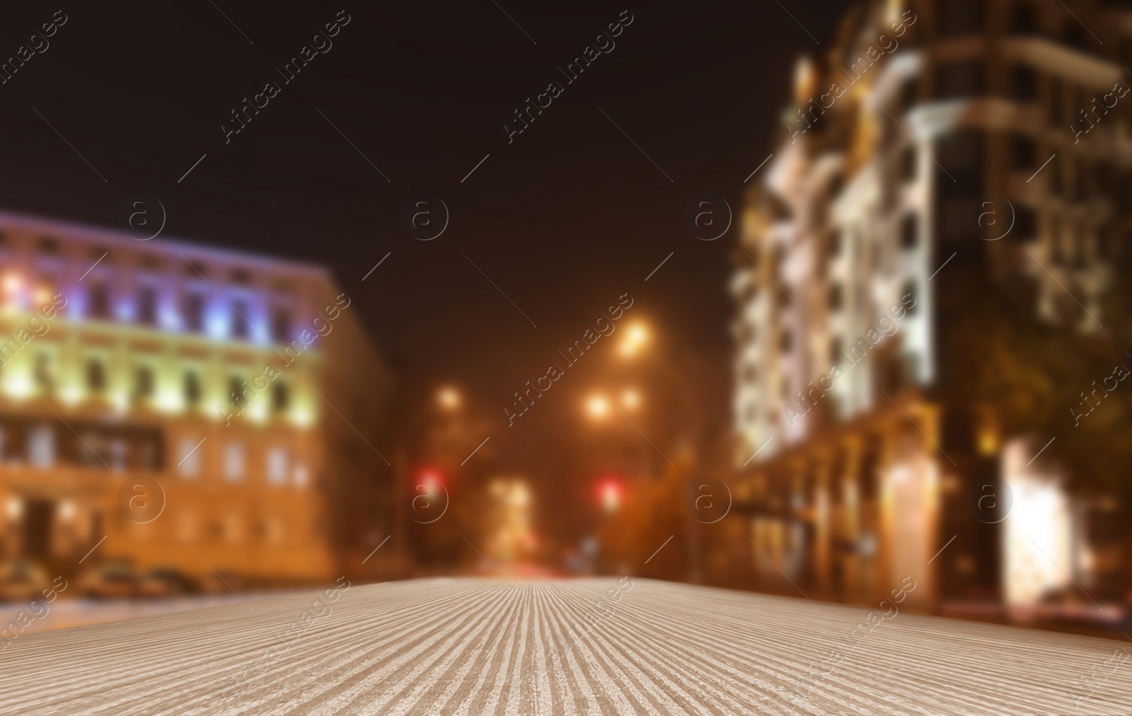 Image of Empty wooden surface and blurred view of night city