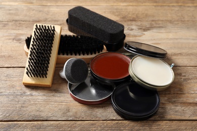 Photo of Composition with shoe care accessories on wooden background