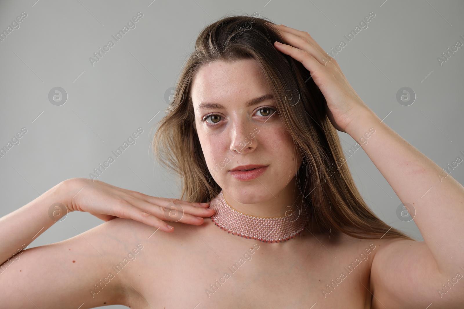 Photo of Portrait of beautiful young woman on grey background