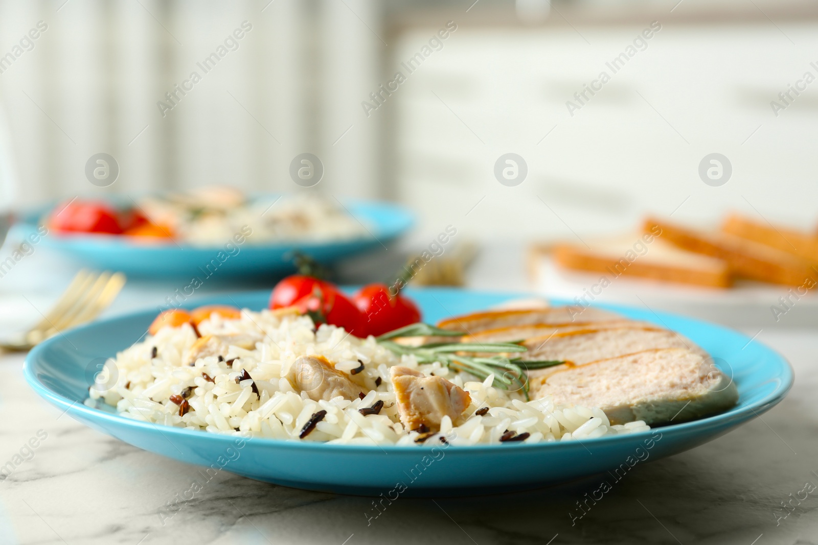 Photo of Delicious rice with chicken served on marble table