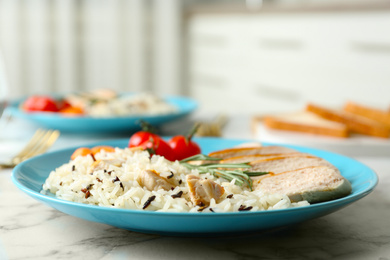 Delicious rice with chicken served on marble table