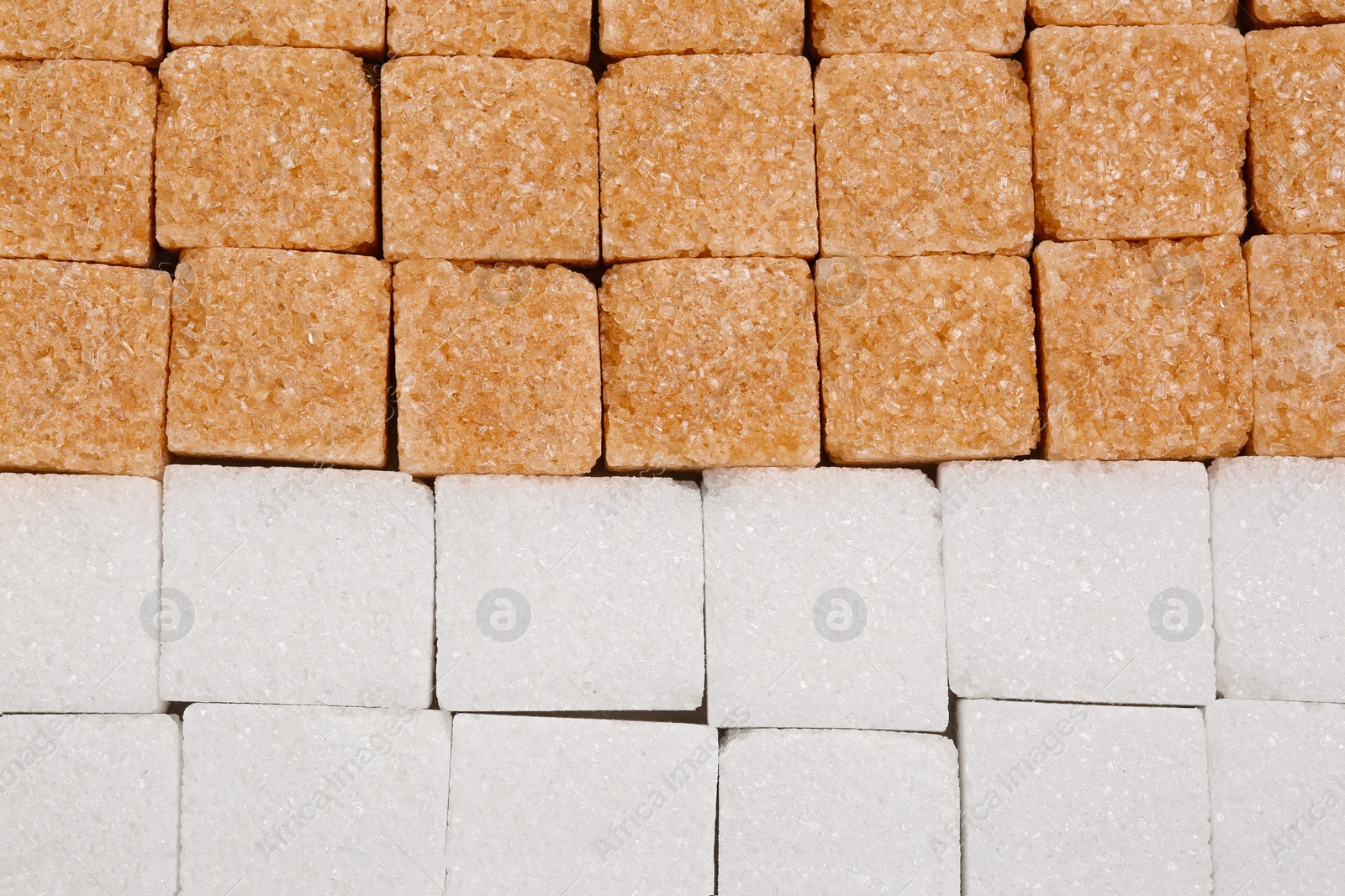 Photo of White and brown refined sugar cubes as background, top view
