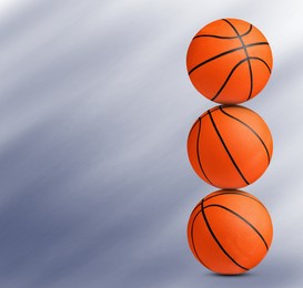 Image of Stack of basketball balls on blue background. Space for text