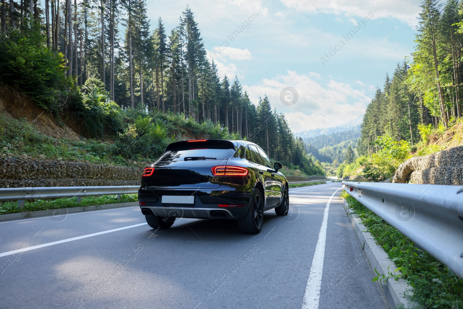 Photo of Picturesque view of asphalt road with modern black car