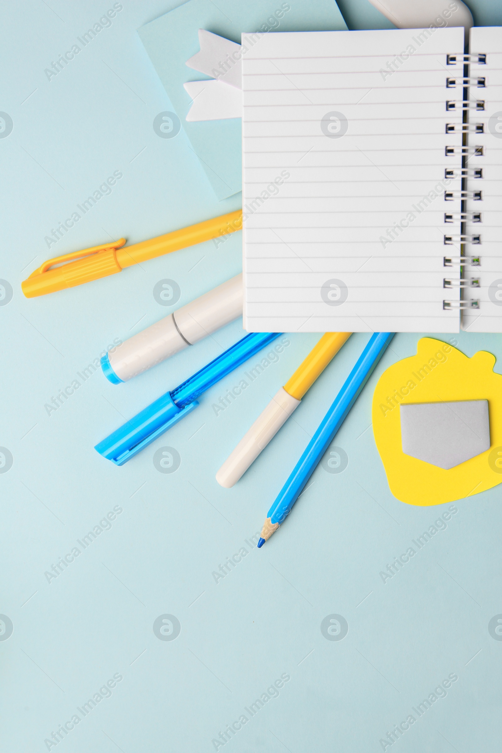 Photo of Different school stationery on light blue background, flat lay with space for text. Back to school