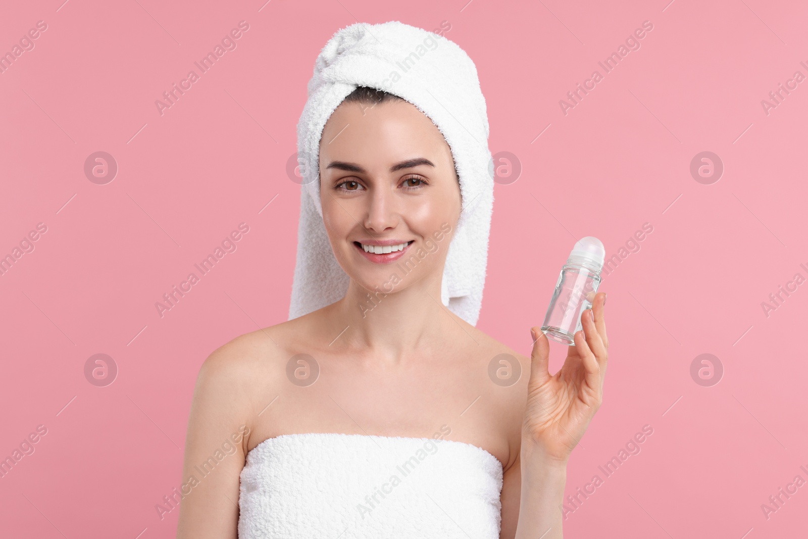 Photo of Beautiful woman with deodorant on pink background