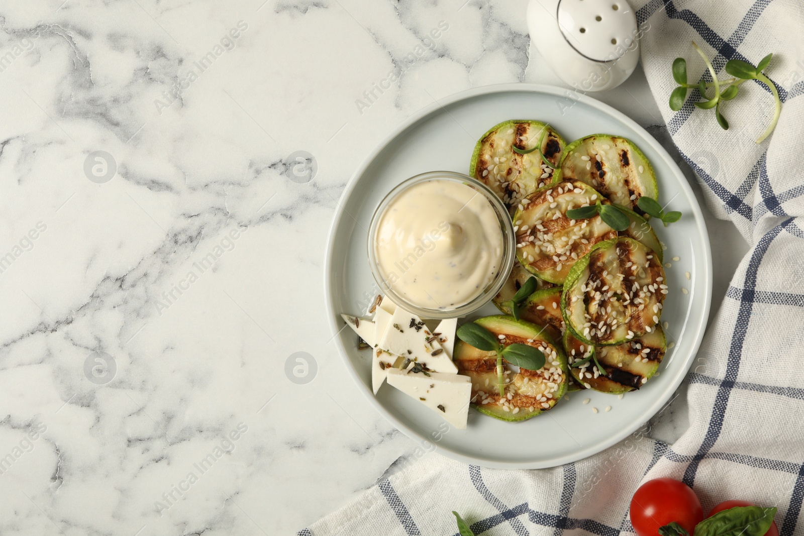 Photo of Flat lay composition with delicious grilled zucchini slices on white marble table, space for text