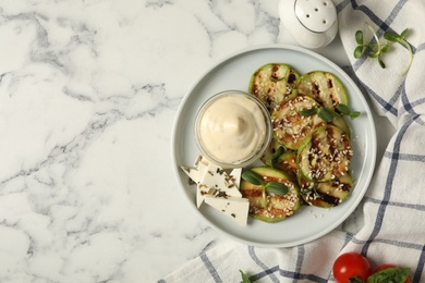 Photo of Flat lay composition with delicious grilled zucchini slices on white marble table, space for text